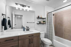 Full bath with vanity, shower / bath combination with curtain, and recessed lighting