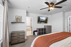 Bedroom featuring carpet, ceiling fan, and connected bathroom