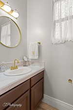 Bathroom featuring vanity and a textured wall