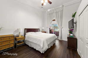 Bedroom with a closet, dark wood finished floors, access to outside, and a ceiling fan