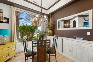 Dining room with suspended lighting, light wood-style flooring, and plenty of natural light