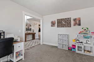 Office featuring light colored carpet and baseboards