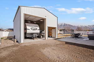 View of outdoor structure with outdoor dining space, and a mountain view