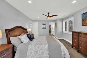 Carpeted Master bedroom featuring ceiling fan, recessed lighting, and ensuite bath