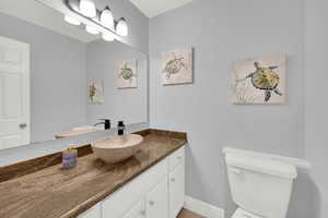 Half bathroom featuring toilet and vanity