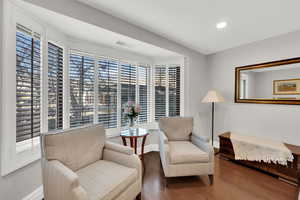 Living area featuring wood-type flooring and recessed lighting