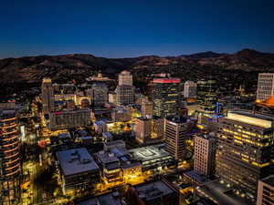 Twilight view of city featuring a mountain view