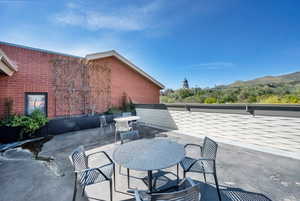 Roof Top View of patio / terrace featuring outdoor dining area and a mountain view