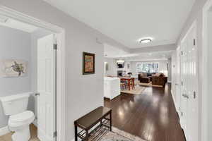 Hallway featuring dark wood-type flooring