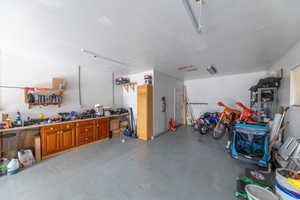 2 car garage is extra deep and features workshop cabinetry.