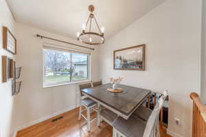 Dedicated dining area flows into kitchen and living room, with view of family room below.