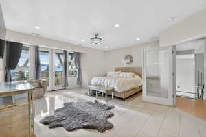 Bedroom with french doors, access to outside, and recessed lighting