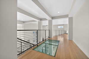 Corridor featuring light wood-style flooring and recessed lighting