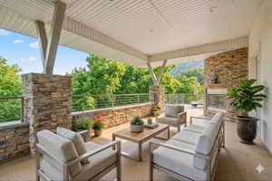 View of patio with an outdoor living space with a fireplace