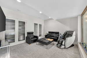 Living area featuring light carpet, recessed lighting, and a textured ceiling