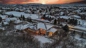 Snowy aerial view featuring a residential view and a mountain view