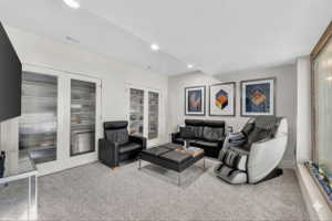 Living area featuring light carpet and recessed lighting