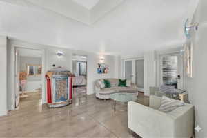 Living room featuring concrete flooring and baseboards