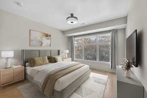 Bedroom with light wood-style flooring and baseboards