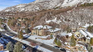 Snowy aerial view with a mountain view and a residential view