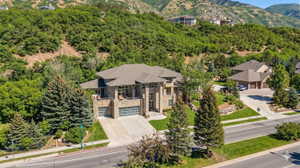 Aerial view of property and surrounding area with a mountain backdrop