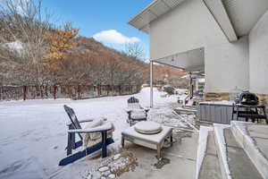 Snow covered patio with a patio