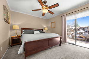 Carpeted bedroom with ornamental molding, ceiling fan, and access to outside