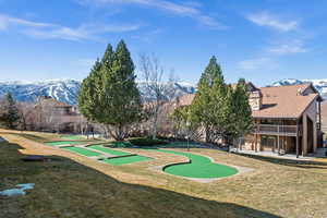 View of home's community featuring a patio area, a putting course, and a mountain view