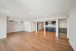 wetbar in the walk out basement with full wall of windows.  Real white oak floors.