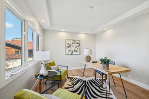 Office space featuring light wood-type flooring and recessed lighting