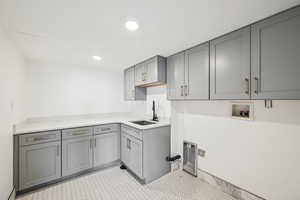 Laundry room featuring cabinet space, washer hookup, and recessed lighting