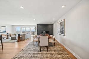 Dining in great room with gas fireplace and city views