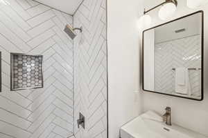 Full bathroom on the main.  Designer tiles, medicine cabinet storage, new lighting and vanity.