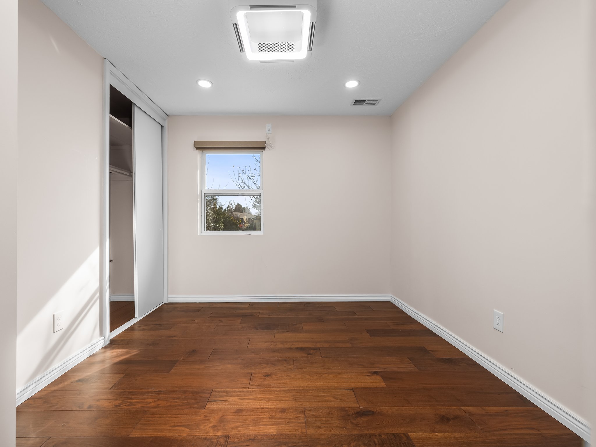 Unfurnished bedroom featuring dark wood finished floors, a closet, and recessed lighting