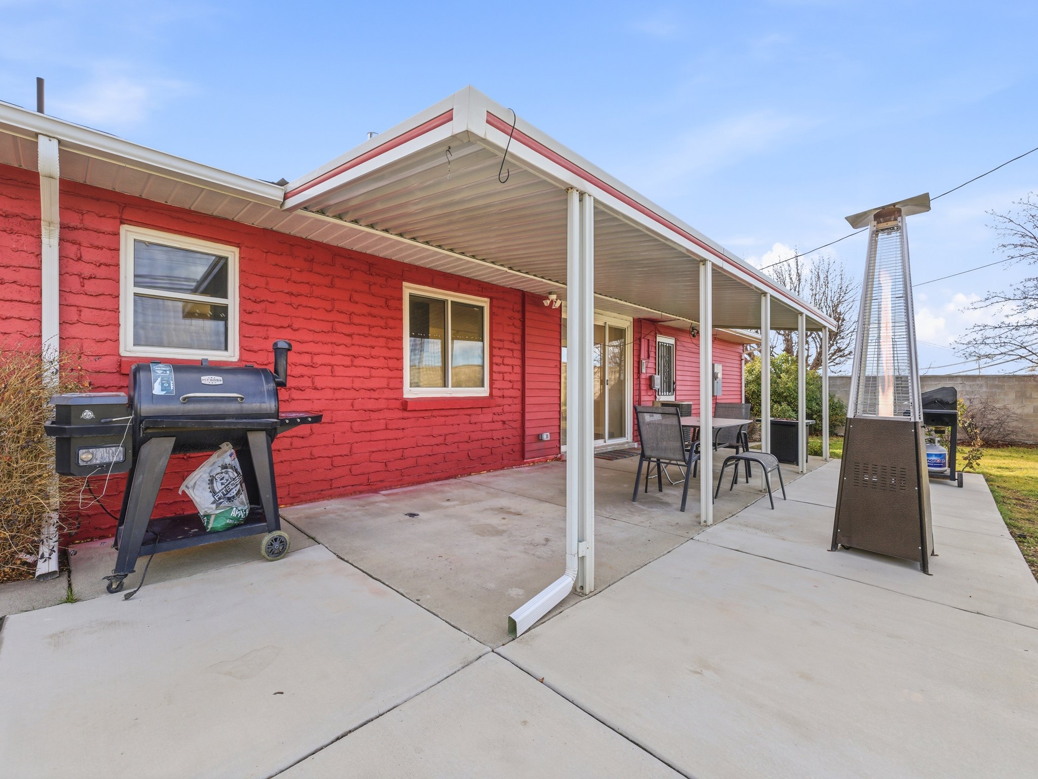 View of patio featuring a grill and outdoor dining area