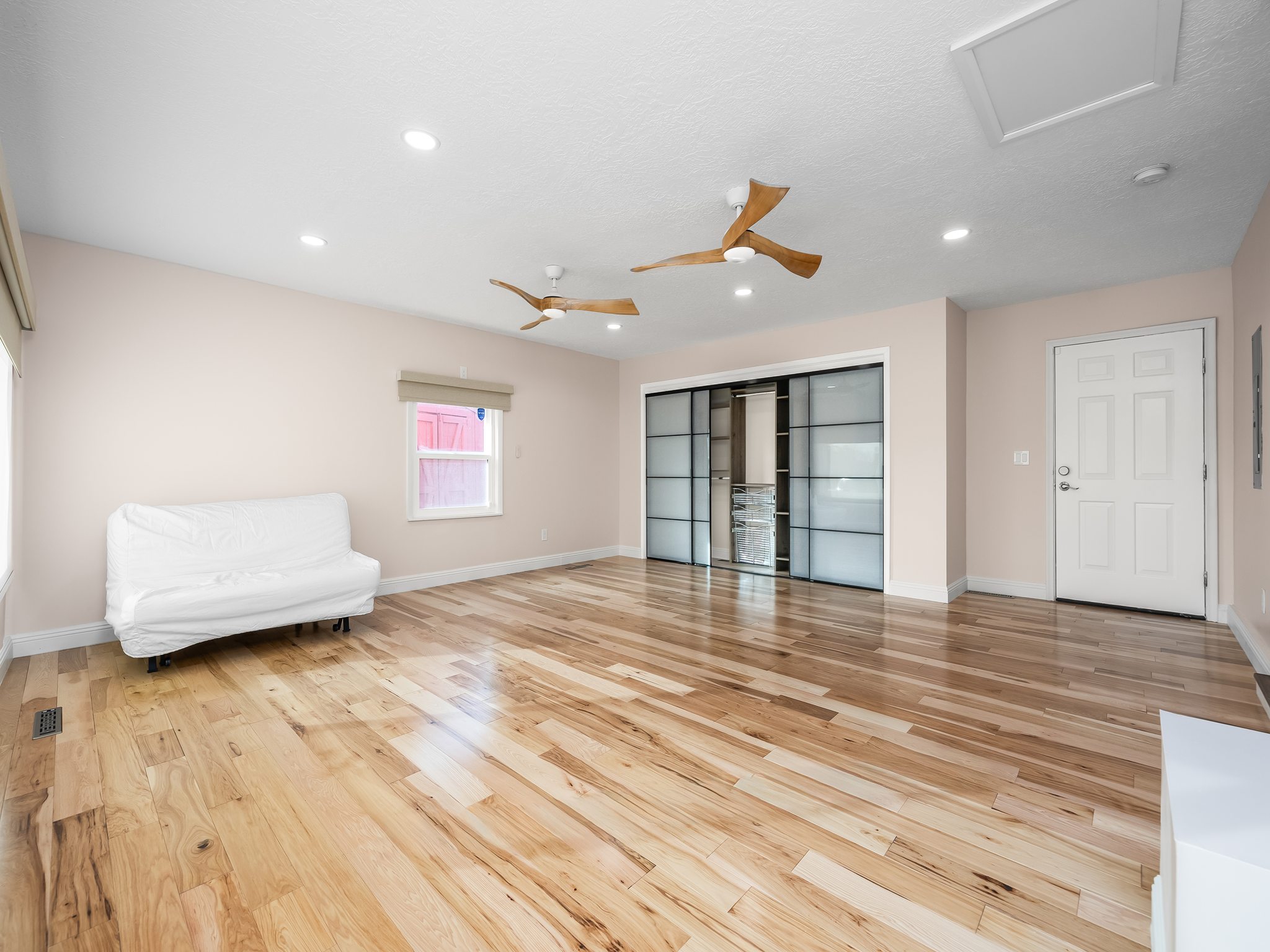 Unfurnished living room with light wood-type flooring, a ceiling fan, and recessed lighting