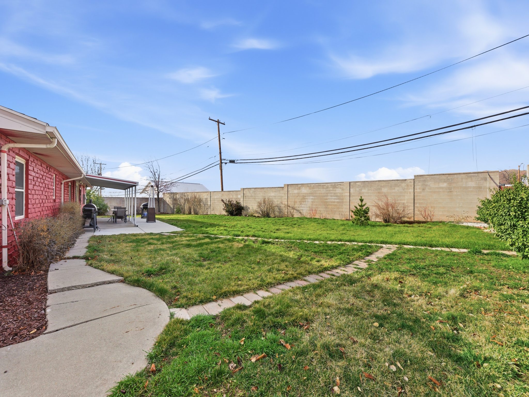 Fenced backyard with a patio
