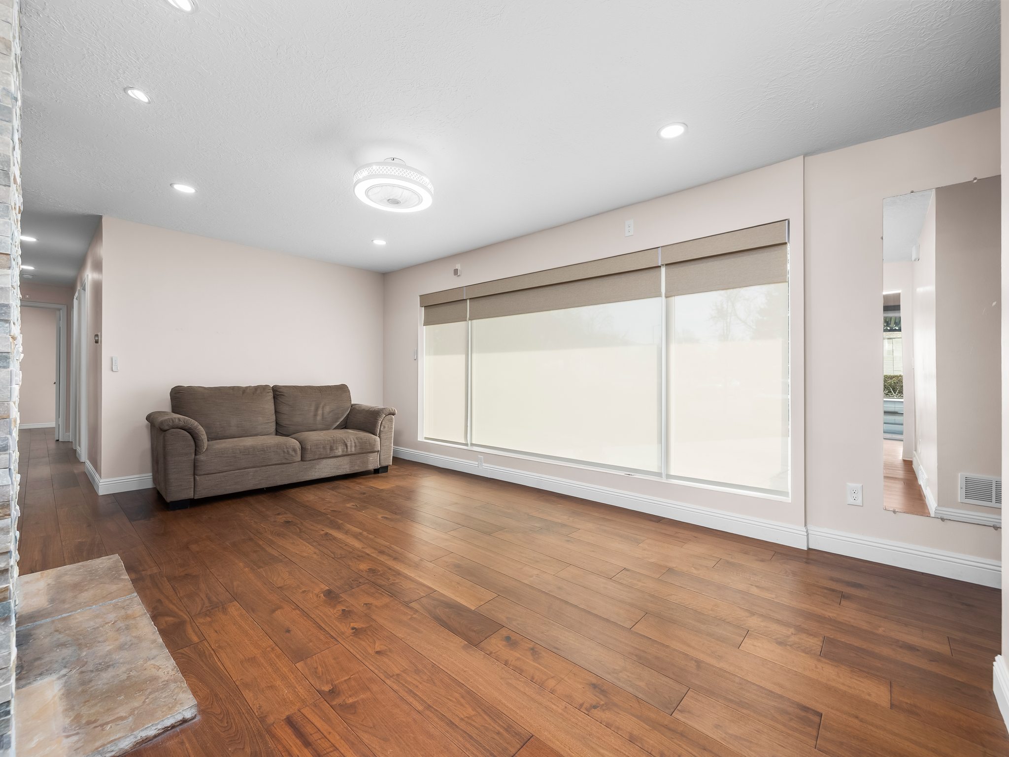 Living room with dark wood-style flooring and recessed lighting