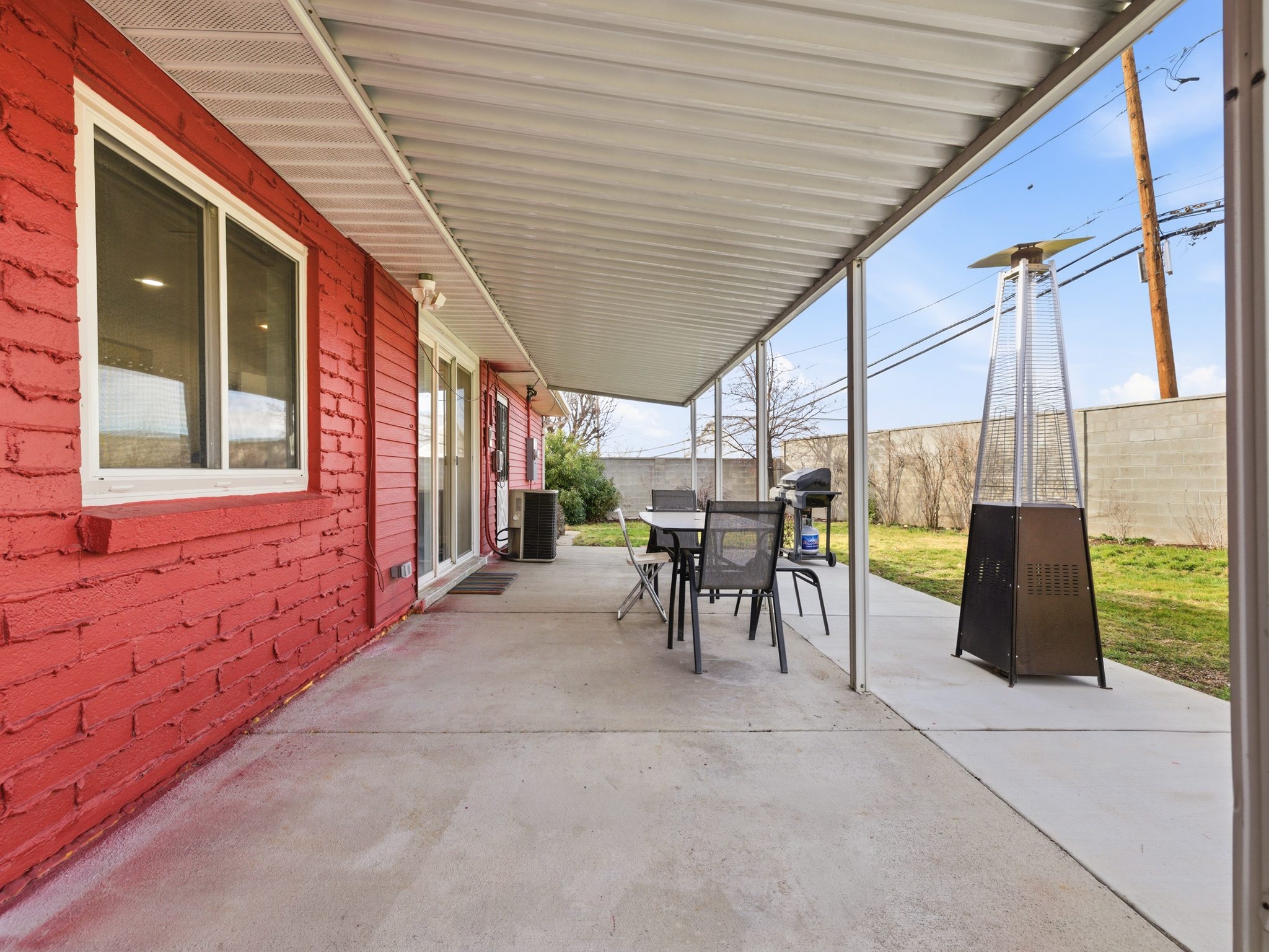Fenced backyard with outdoor dining area, area for grilling, and a patio