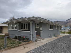 View of front of home featuring a gate, a mountain view, entry steps, and brick siding