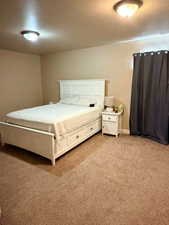 Bedroom featuring light carpet