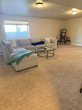 Carpeted living room featuring baseboards