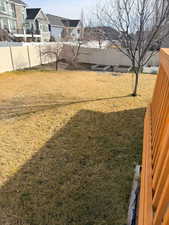 Fenced backyard with a residential view