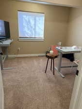 Office space with light carpet and baseboards