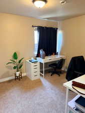 Office area with light colored carpet and baseboards