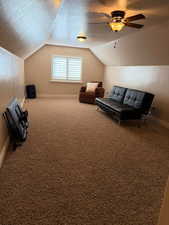 Sitting room featuring a textured ceiling, carpet, and ceiling fan