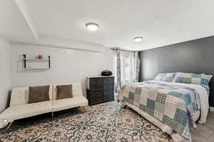 Bedroom featuring a textured ceiling and wood finished floors