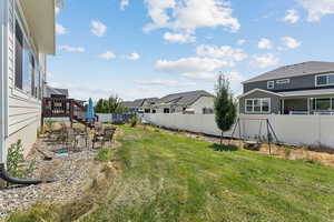 Fenced backyard with a patio area and a residential view