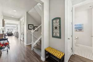 Foyer entrance featuring dark wood-style flooring, recessed lighting, and a textured ceiling