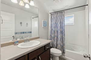 Bathroom featuring vanity and shower / tub combo with curtain